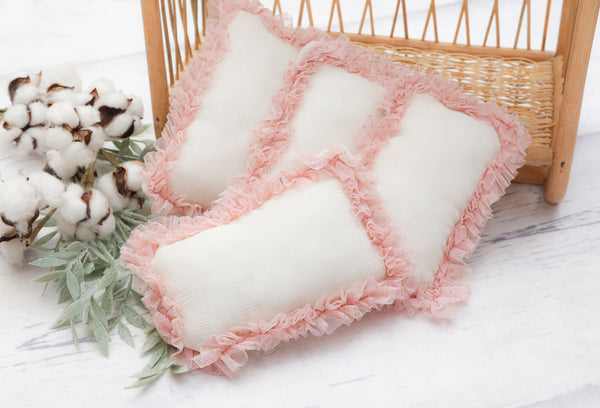 pink and white newborn pillow